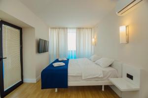 A bed or beds in a room at DOWNTOWN Centre in Batumi Aparthotel Orbi City N1