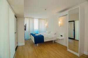 A bed or beds in a room at DOWNTOWN Centre in Batumi Aparthotel Orbi City N1