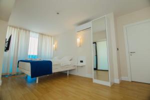 A bed or beds in a room at DOWNTOWN Centre in Batumi Aparthotel Orbi City N1