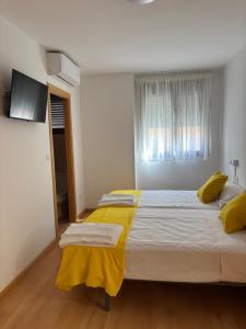 En eller flere senge i et værelse på Hostal Batallar