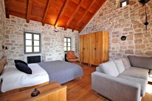 a bedroom with a bed and a couch at Villa Kuk in Bol
