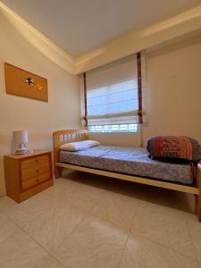 a small bedroom with a bed and a window at Tropicana in Benicàssim +30 photos