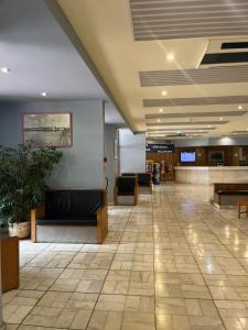 a lobby with a waiting area with couches and tables at Praia da Rocha Apartamento Costa Azul in Portimão +34 photos