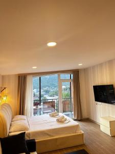 a bedroom with a large bed and a large window at Woodland Borjomi in Borjomi