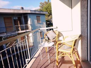 a yellow chair sitting on a balcony at La casa dei Sogni e dintorni in Cervo