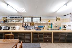 a large kitchen with wooden counters and a table at 110 House 4Bedroom in Ban Zong Katiam