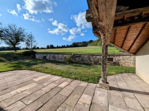 a porch of a house with a view of a field at Maison spacieuse près de Vesoul avec cheminée, idéale pour familles - FR-1-583-434 in Dampierre-sur-Linotte