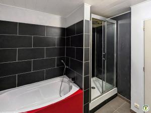 a bathroom with a white tub and a glass shower at Gîte spacieux au cœur des Vosges du Sud avec jardin et parking sécurisés - FR-1-583-462 in Errevet +20 photos