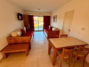 a living room with a couch and a table at Hotel Rio Sauce in Sierra de la Ventana