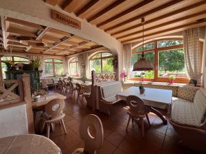 a restaurant with tables and chairs and windows at Hotel Alte Rose Gasthaus in Ebelsbach
