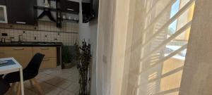 a kitchen with a table and a window in a kitchen at Alloggio Turistico Tedeschi in Santa Maria delle Mole