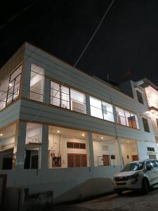 a car parked in front of a building at night at Raj Sadan Homestay in Ayodhya