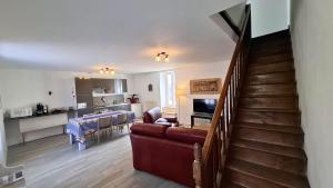 a living room with a staircase leading to a kitchen at Gîte les Herbiers in Les Herbiers