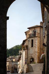 a view of a town from an archway at Santa Chiara Apartment in Assisi