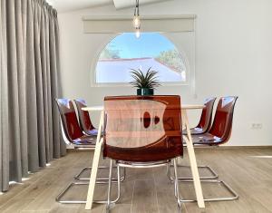 a table and chairs in a room with a window at Stone Villa in Chayofa