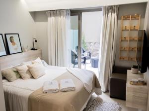 a bedroom with a bed with two towels on it at Joy Tower by FMA Coliving in Salta +28 photos