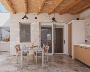 a kitchen and dining room with a table and chairs at Al Borgo 01 Luxury Suites in Sardinia in Abbasanta