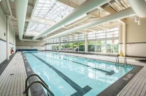 a large indoor swimming pool with a large window at Lucy's House in Vancouver