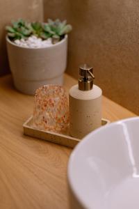 a roll of toilet paper on a table with a plant at Goddess Thea Sea Apartment! in Iraklitsa +21 photos