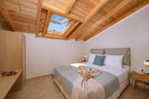 a bedroom with a bed with a teddy bear on it at Goddess Thea Sea Apartment! in Iraklitsa