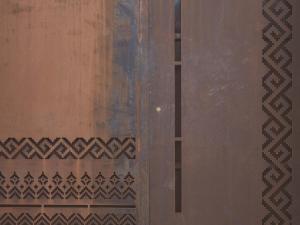a wooden door with intricate patterns on it at Al Borgo 01 Luxury Suites in Sardinia in Abbasanta