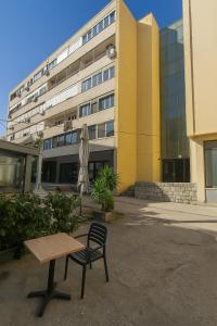 een tafel en een stoel voor een gebouw bij Modern living apartment Airy in Split