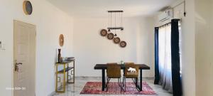 a dining room with a table and two chairs at White Rhino apartments & tours in Livingstone