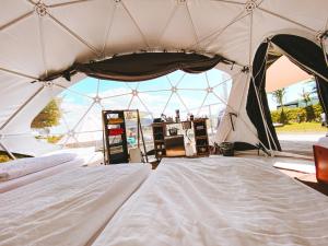 a large tent with a bed in it at DOMO CAMP Sylt - Glamping Camp in Westerwall