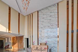 a lobby with a marble wall at Palette - The Mark Club & Resorts in Durg