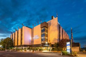 a building with a lit up facade at night at Hotel Bologna Airport in Bologna