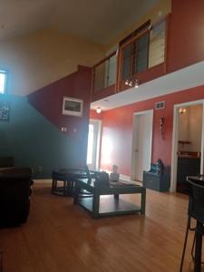 a living room with a table in the middle of a room at Zoo Town House with Sauna in Missoula