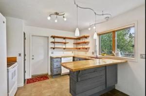 a kitchen with a wooden counter top in a room at Zoo Town House with Sauna in Missoula