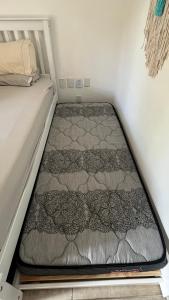 a bed in a small room with a mattress at Pé na Areia no Cumbuco - Eco Paradise 110 in Caucaia +37 photos