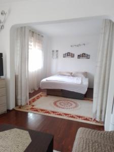 a bedroom with a bed in the corner of a room at Edinhome in Sarajevo