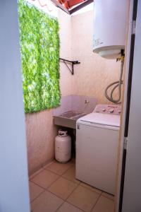 a small kitchen with a sink and a refrigerator at Departamento Palo Verde in Hermosillo