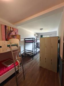 a dorm room with bunk beds and a closet at High Hostel in Budva