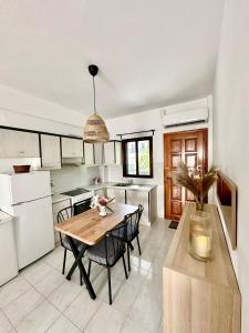 a kitchen with a table and chairs in a room at Sea La Vie - Premium in Polychrono