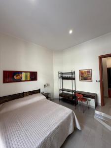 a bedroom with a white bed and a red chair at Misciù in Naples +35 photos