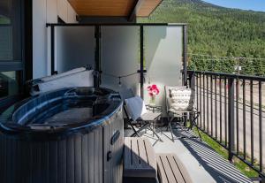 a hot tub on the balcony of a house at Wildflower Retreat by Revelstoke Vacations in Revelstoke