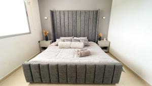 a large bed with two pillows on it in a bedroom at Magico PentHouse Duplex Frente al Mar 3 Habs FB112 in Coveñas