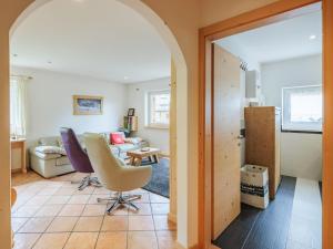 a living room with an archway leading into a living room at Apartment Erika by Interhome in Canazei