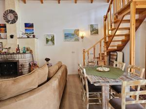a living room with a couch and a table at River Escape Villa - Private Beach, Scenic View & BBQ in Tepelenë
