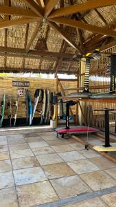 a room with surfboards hanging on a wall at Pé na Areia no Cumbuco - Eco Paradise 110 in Caucaia