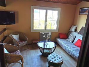 a living room with a couch and a table at La Villa in La Tranche-sur-Mer
