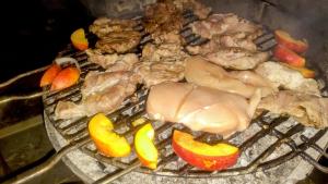 a bunch of meat and vegetables on a grill at High Hostel in Budva
