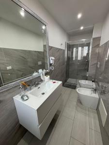 a bathroom with a sink and a toilet and a shower at B&B Le Ninfee in Marina di Gioiosa Ionica