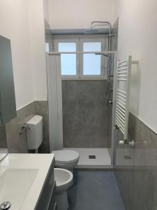 a bathroom with a toilet and a sink and a shower at Volver Apartment in Margherita di Savoia