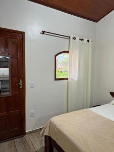 Postel nebo postele na pokoji v ubytování Recanto Casa Amarela