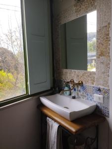a bathroom with a sink and a mirror and a window at Casa Sole Luna in Torre del Greco