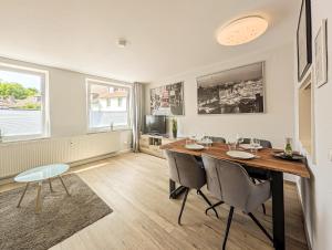 a dining room with a wooden table and chairs at H-Lodges - TOP City-Appartments in Essen in Essen